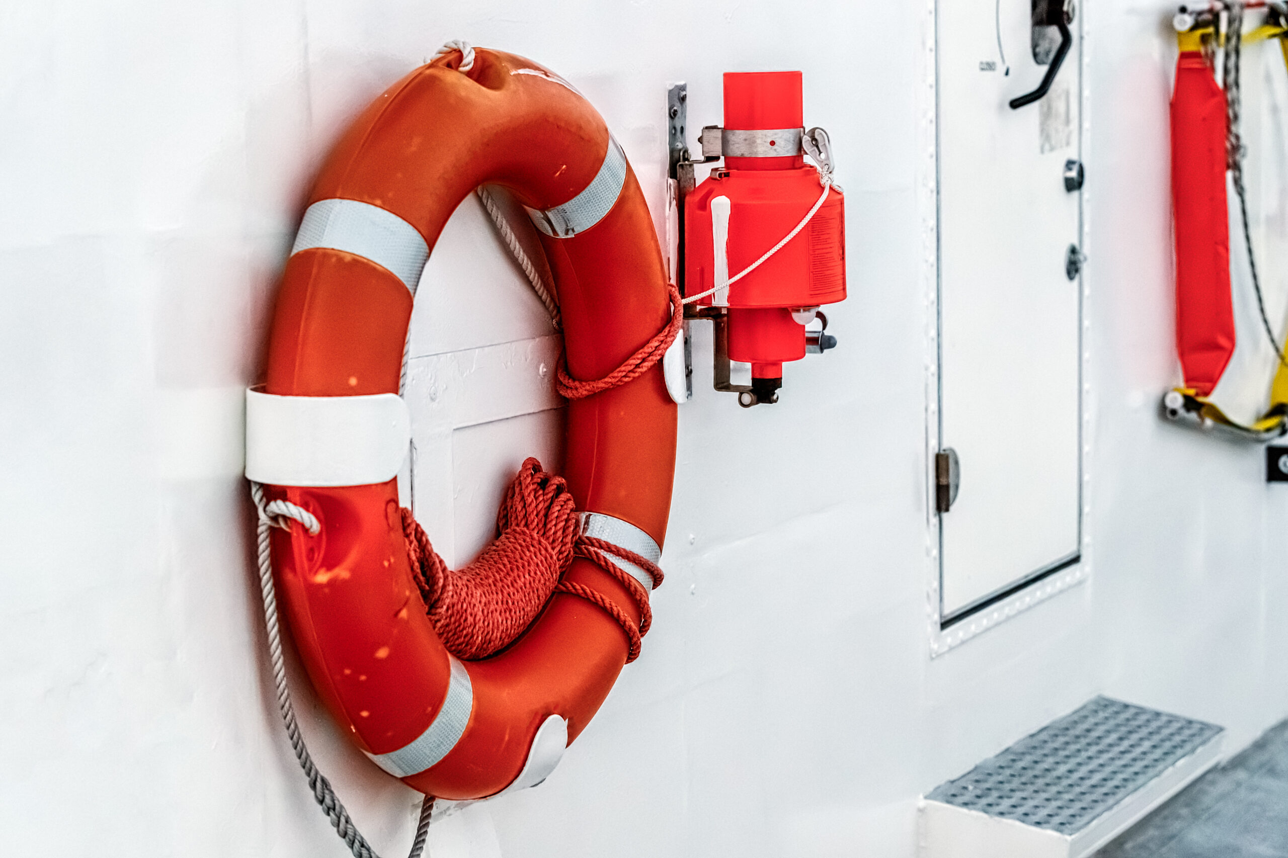 Lifebuoy is fixed on hull of a ship. Side view. Lifebuoy is fixed on hull of a ship. Side view.
